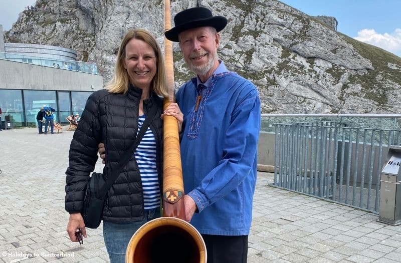 Woman with an Alphorn player at Mt. PIlatus