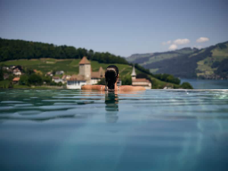 Woman in the infinity pool at Belvedere Strandhotel in Spiez, Switzerland