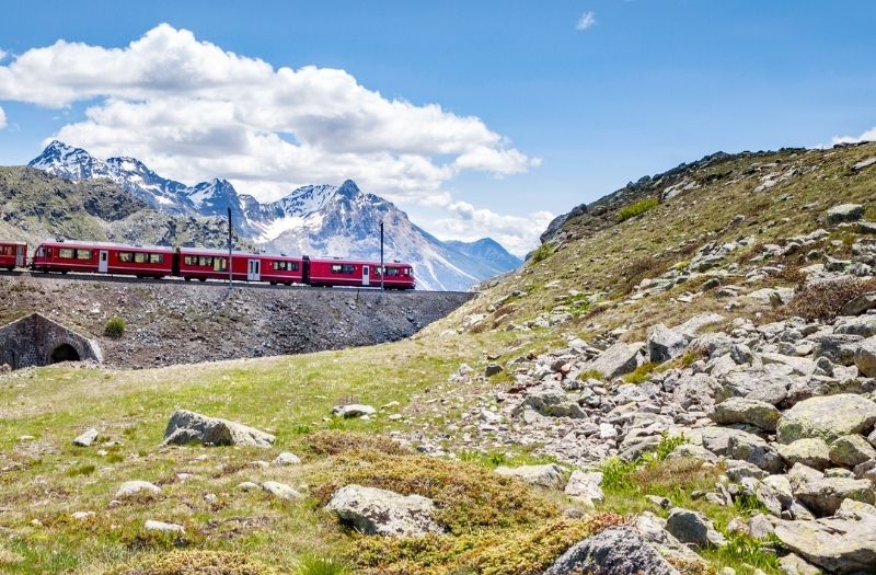 Bernina Express train travelling through mountainous Switzerland