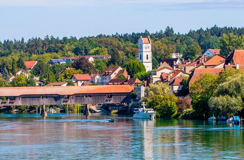 A medieval wooden bridge crosses the River Aare in the village of Büren an der Aare.