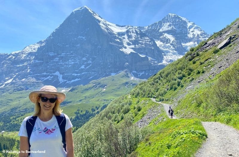 Woman on Panorama Trail near Mannlichen with Eiger and Monch in the background