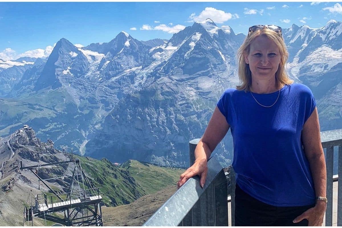 Woman standing in front of Swiss Alps