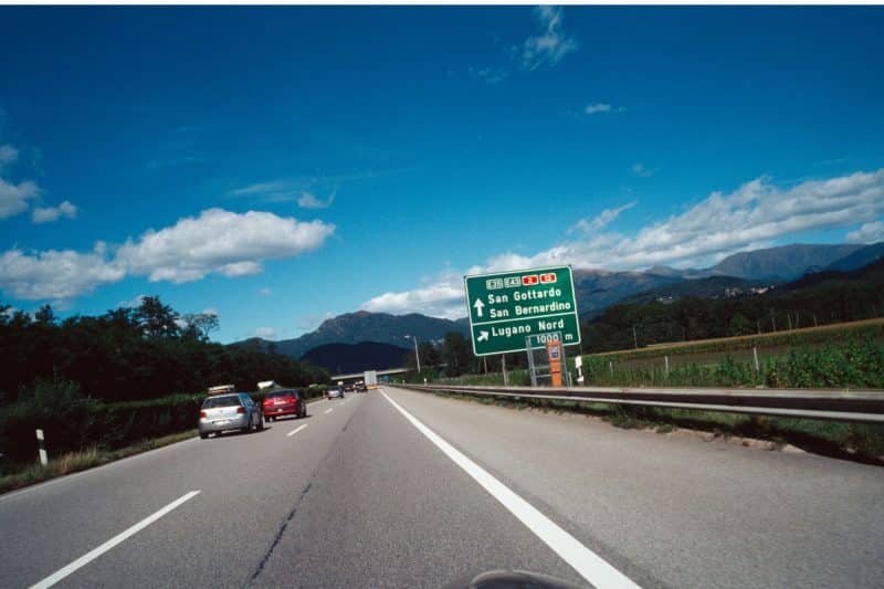 Cars drive on a road in Ticino Switzerland