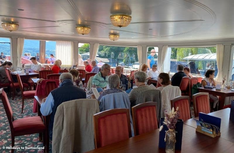 Passengers dining onboard a ship on Lake Lucerne