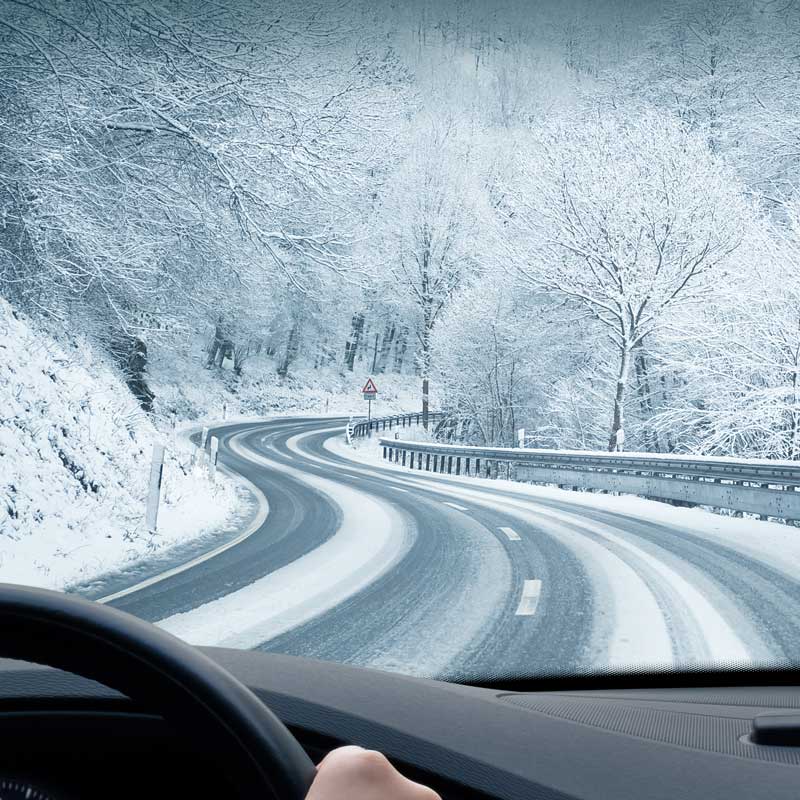 Car driving on snowy roads in winter