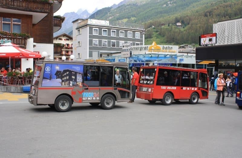 Electric taxis wait outside the Zermatt train station