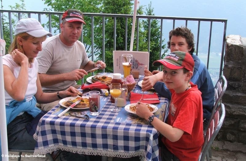 Family enjoying a meal at an outdoor restaurant