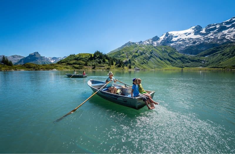 People rowing boats on Lake Trub (Trubsee) at Mt. Titlis, Switzerland