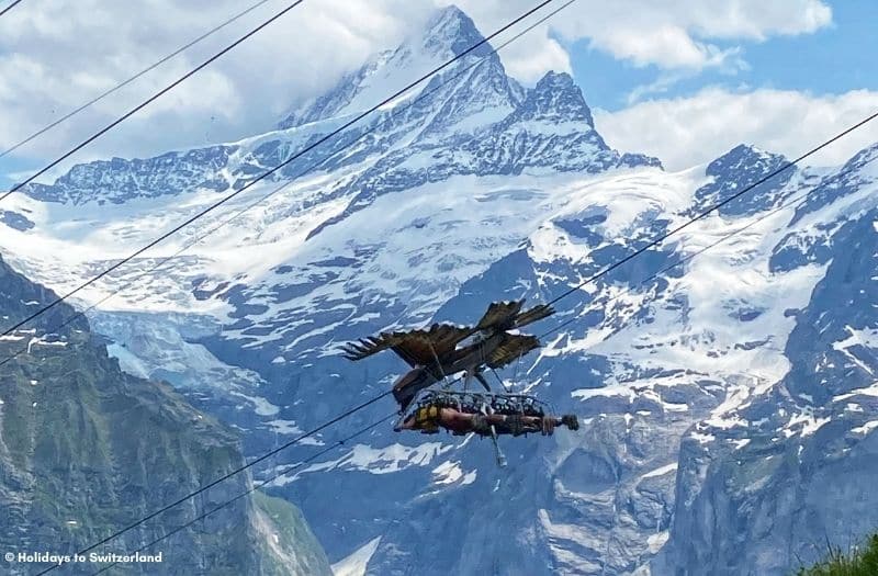 Riders are pulled along a cable on the First Glider rider at Grindelwald First in Switzerland