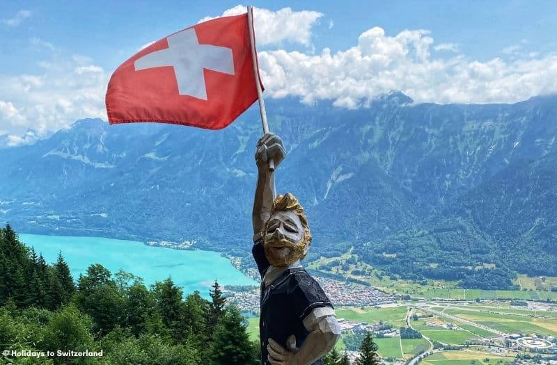 Wooden statue waving a Swiss flag at Harder Kulm.