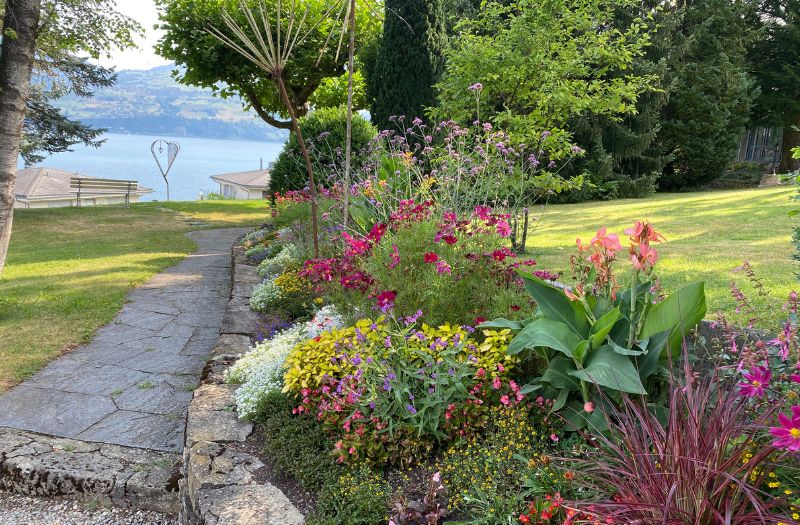 Garden at Belvedere Strandhotel in Spiez looking towards Lake Thun