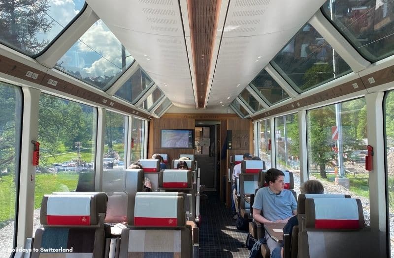 An interior view of a 1st class coach on the Glacier Express