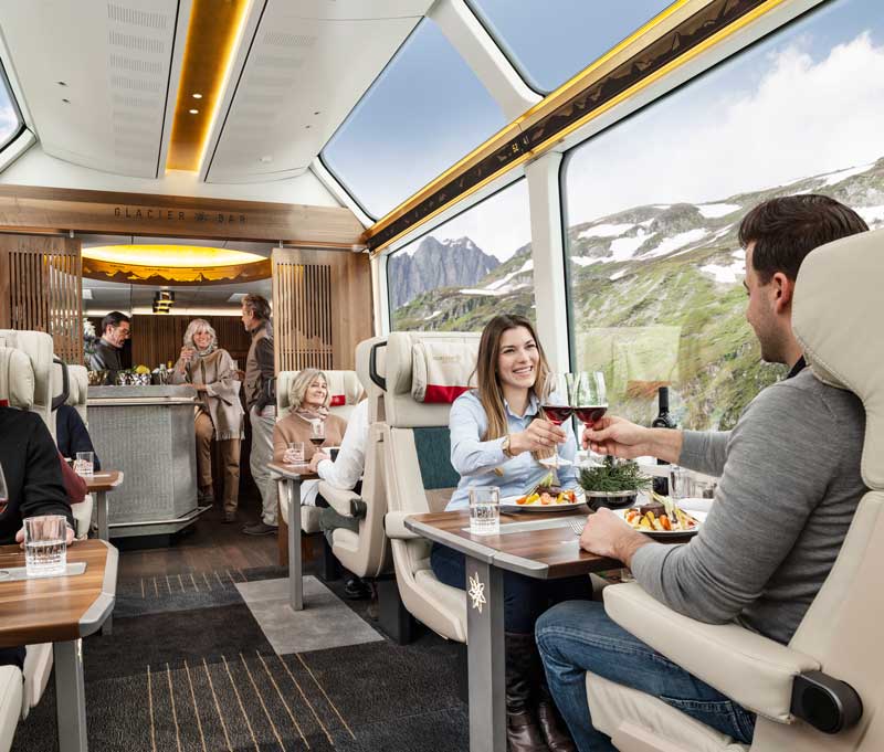 Passengers enjoying a meal in the Glacier Express Excellence Class carriage