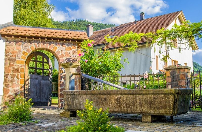 An old water trough and an arched gate in Grandvillard Switzerland