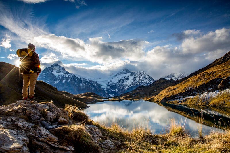 Woman standing beside Bachalpsee lake near Grindelwald, Switzerland.