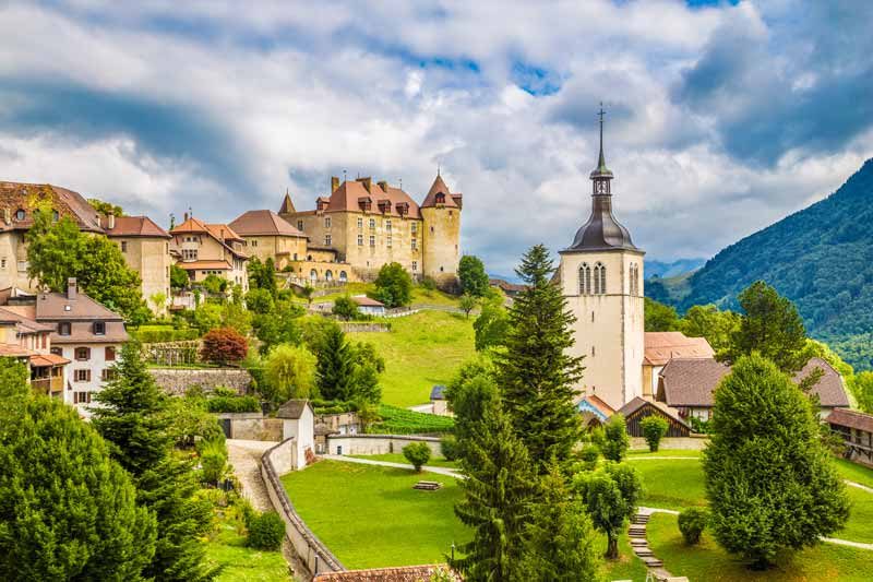 Castle sitting on a hilltop in Gruyeres, Switzerland.