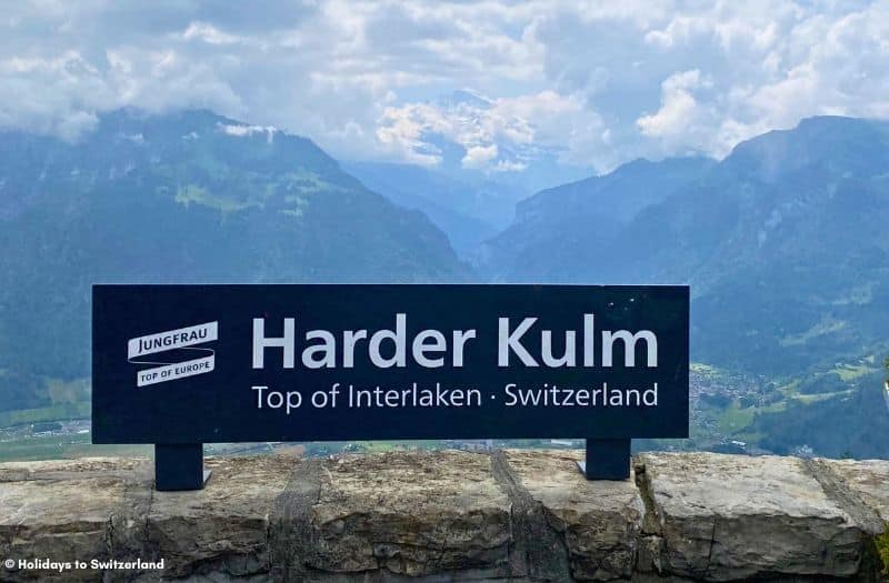 Harder Kulm sign with Bernese Alps in the background.