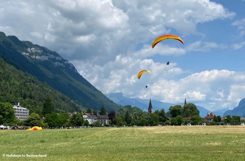 Paragliders coming in to land at Hohematte in Interlaken