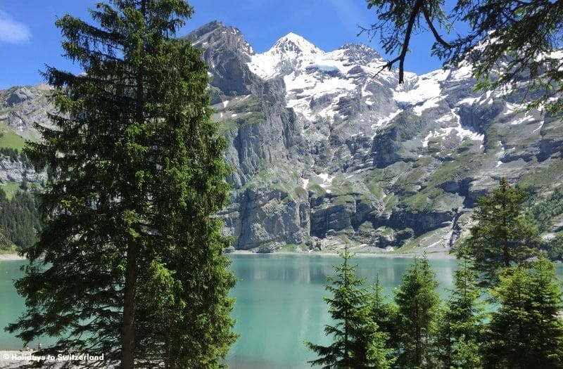 Lake Oeschinensee with snow capped mountain backdrop