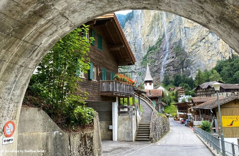 Lauterbrunnen church and Staubbach Falls viewed through an archway