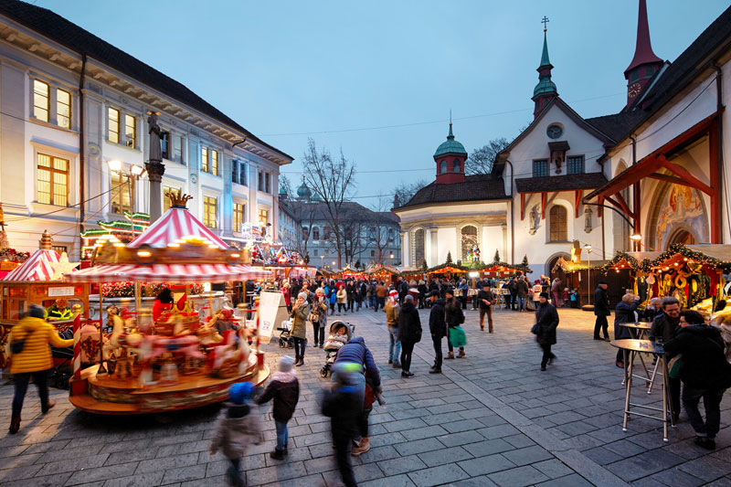 Children approach a carousel at Lucerne Christmas Market