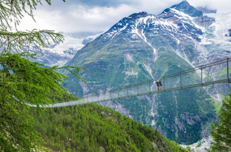 Two children standing on Randa Suspension Bridge near Zermatt in Switzerland