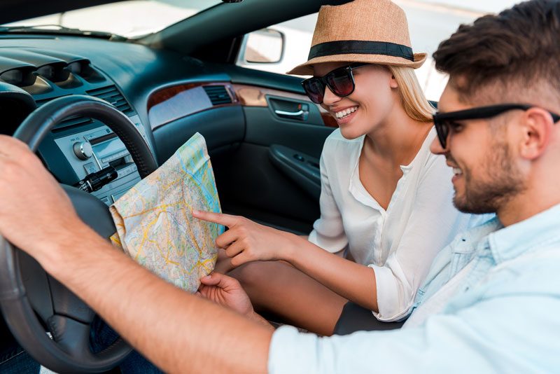 Man and woman looking at a map whilst in a car