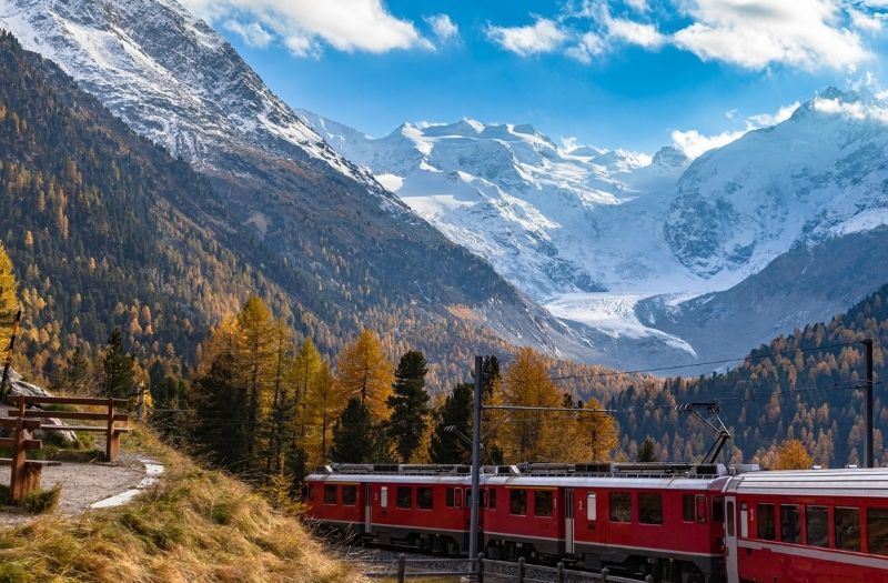 A Rhaetian Railways train passes the Morteratsch Glacier in Graubunden, Switzerland.