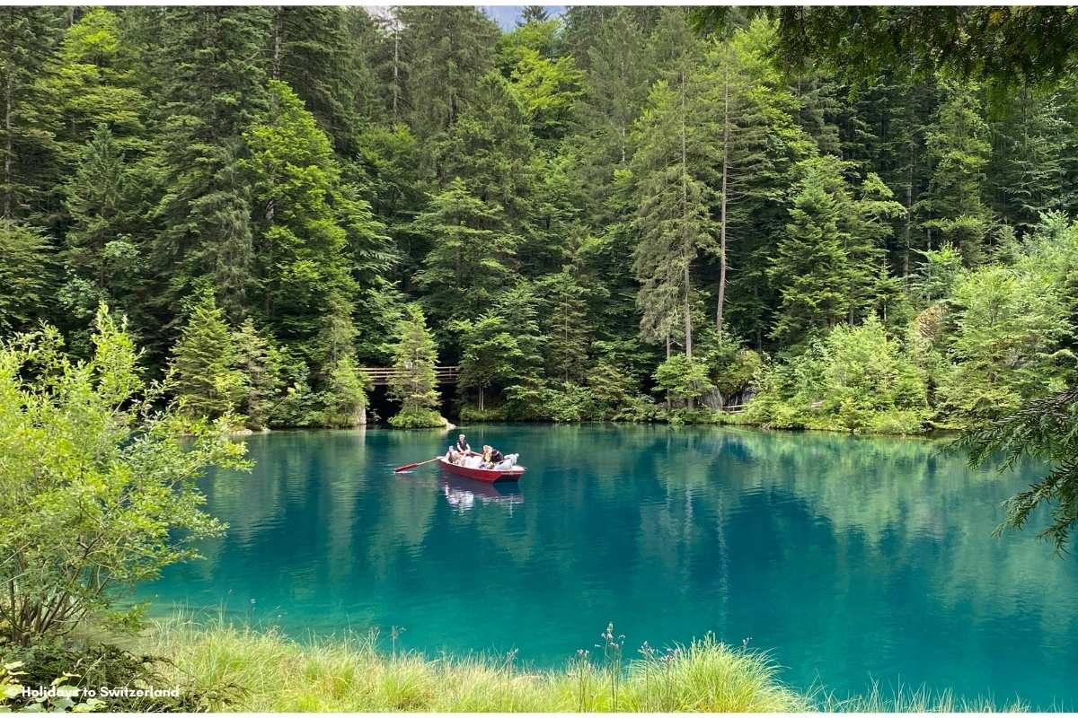 A red rowboat on Blausee in the Blausee National Park, Bernese Oberland, Switzerland