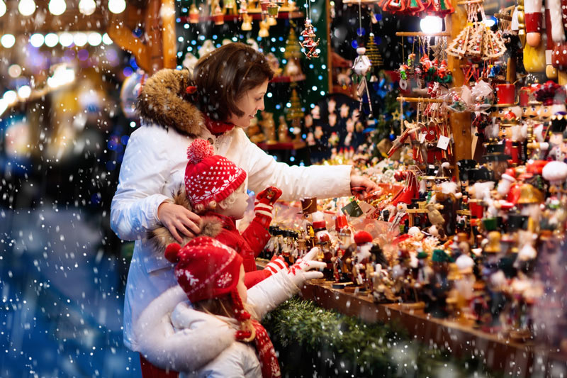 Mother and her children shopping at a Christmas market