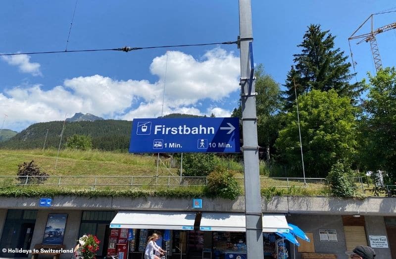 Sign at Grindelwald railway station indicating the direction of the Firstbahn