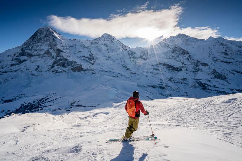 A skier looks toward the Eiger, Monch and Jungfrau in Switzerland