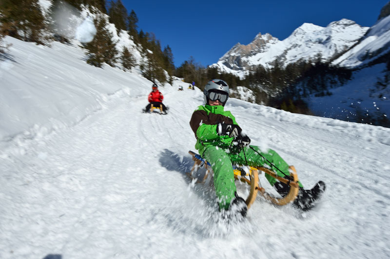 Sledding at Lake Oeschinen, Switzerland