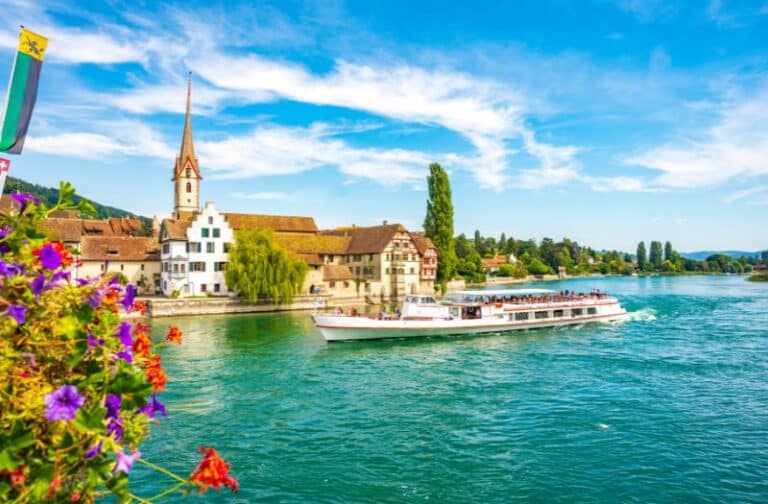 A boat sails on the Rhine River beside the village of Stein am Rhein in Switzerland