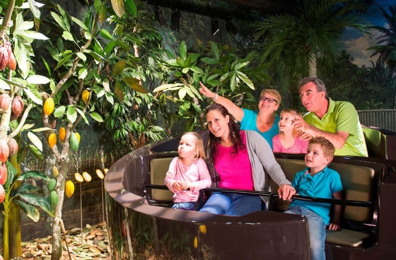 Family on a ride through the Swiss Chocolate Adventure in Lucerne, Switzerland.