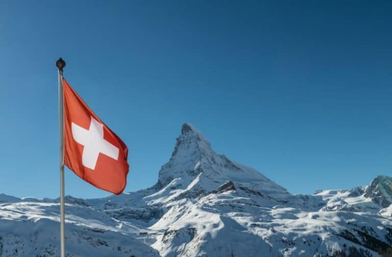 Swiss flag in front of the Matterhorn