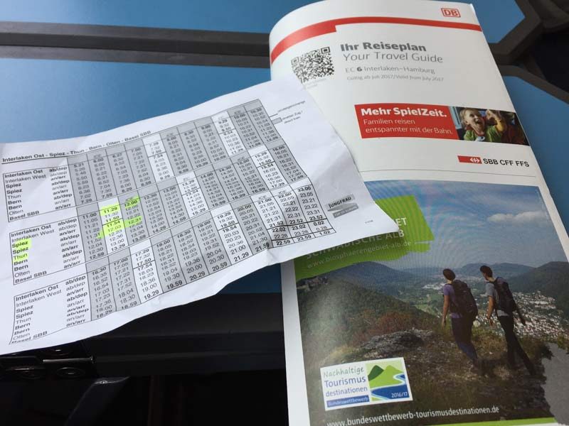 Printed copies of a Swiss train timetable