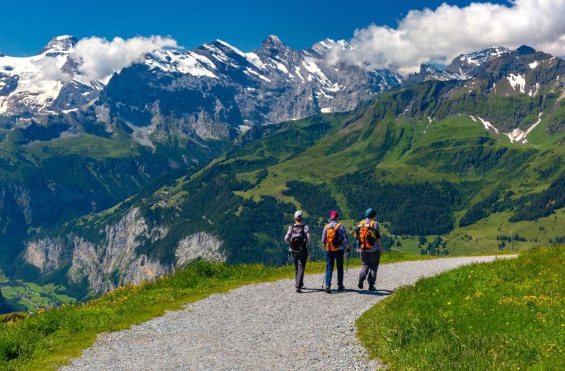 Three hikers on a trail near Mannlichen in Switzerland