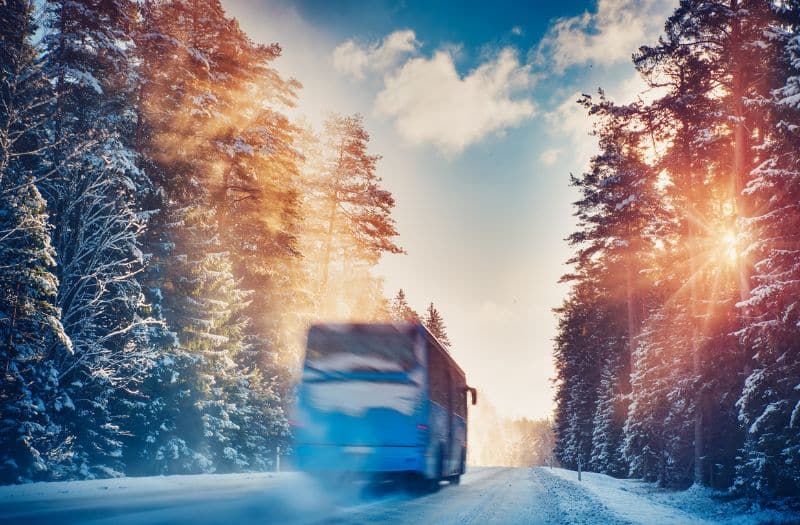 Tour bus driving on snowy road