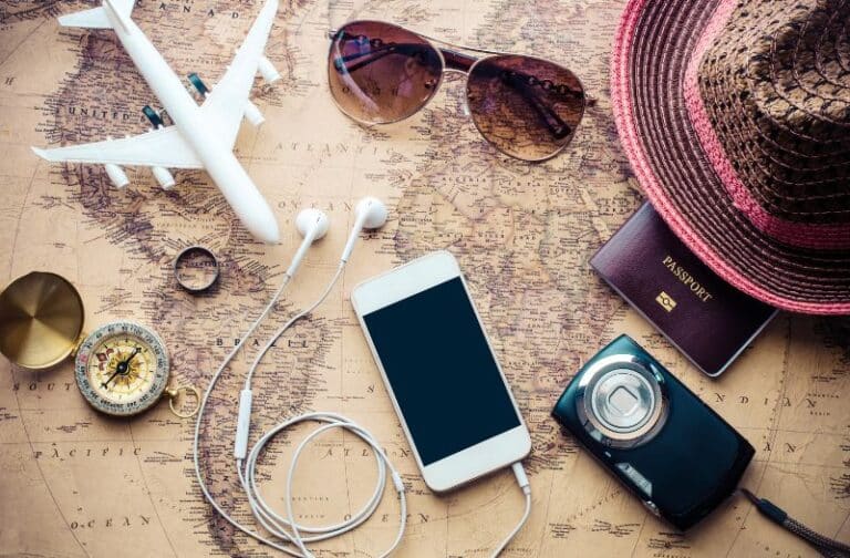 Essential items for travelling including phone, camera, passport and map