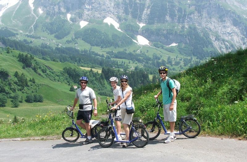 Family on Trotti bikes at Mt. First near Grindelwald in Switzerland