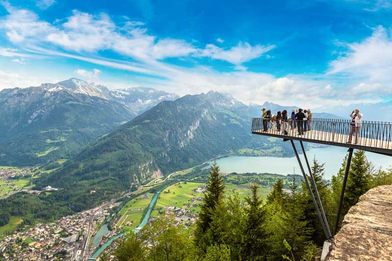 Tourists looking at the view from Two Lakes Bridge at Harder Kulm, Interlaken.