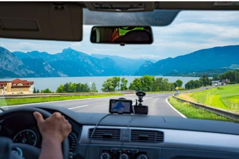 View from inside a car as it travels beside a lake in Switzerland