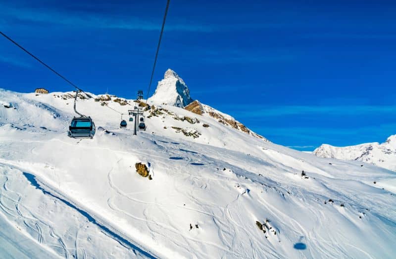 View of cable cars to the snow covered Klein Matterhorn Peak Station at Zermatt Village in Switzerland