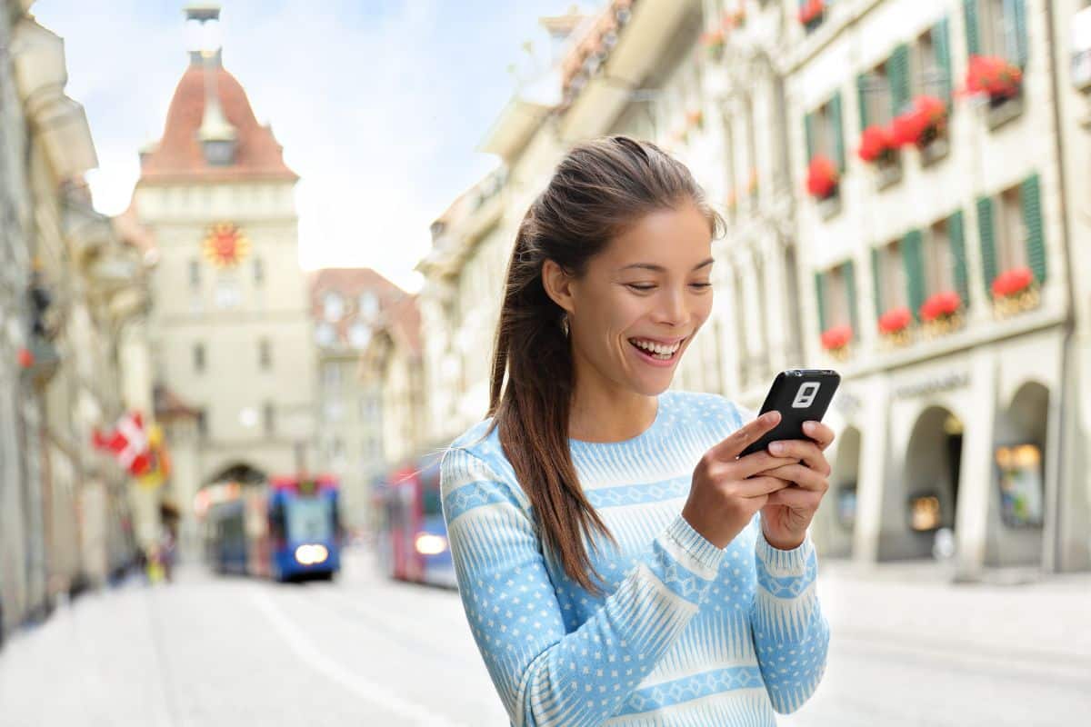 Woman using phone in bern, Switzerland