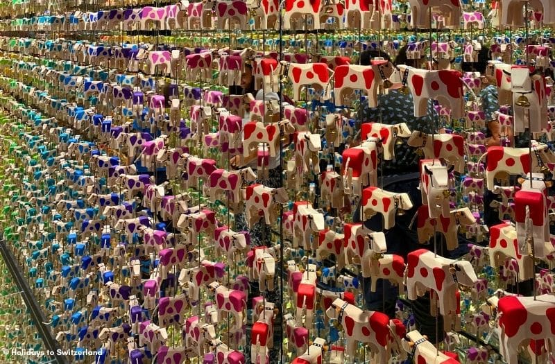 A display of brightly painted wooden cows at Trauffer Switzerland.