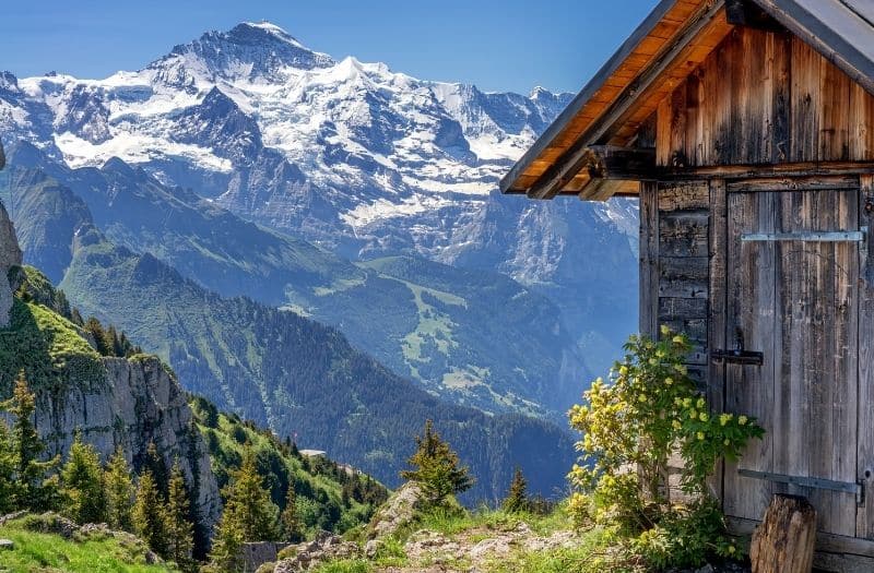 Wooden hut at Schynige Platte with view to Swiss Alps